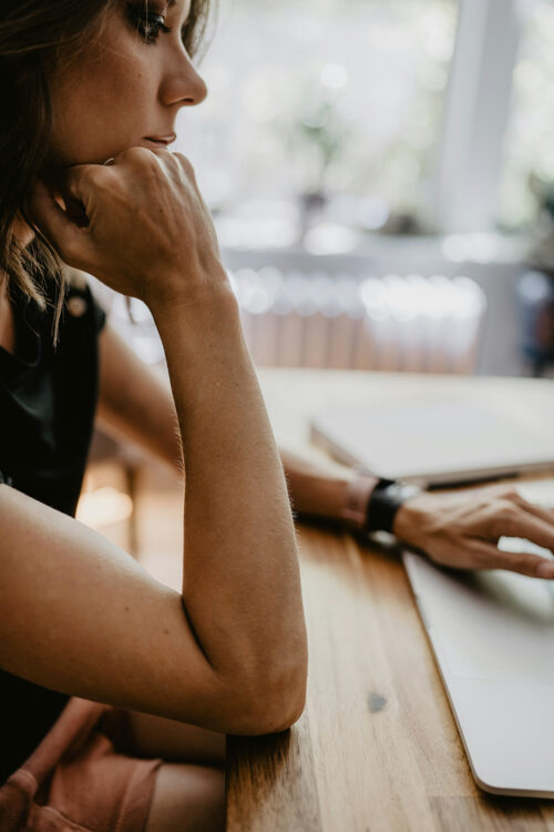 A midlife woman tests subject lines for her email marketing campaigns.